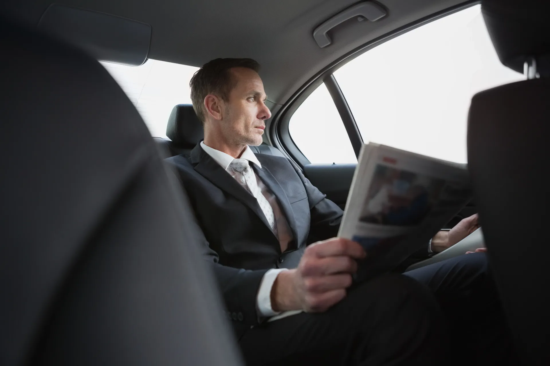 Executive working in back of car