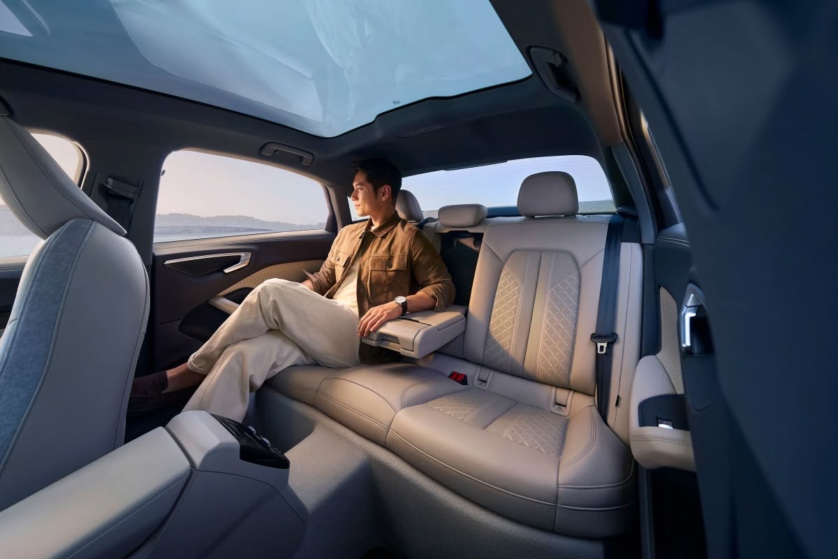Chauffeur opening door for executive